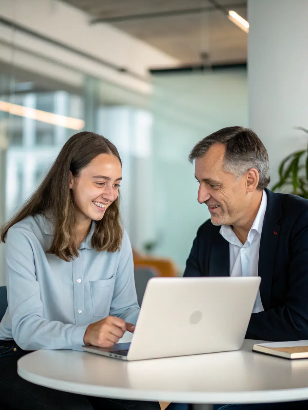 An image of a mentor and mentee engaged in a focused discussion in an office setting, illustrating executive mentoring.